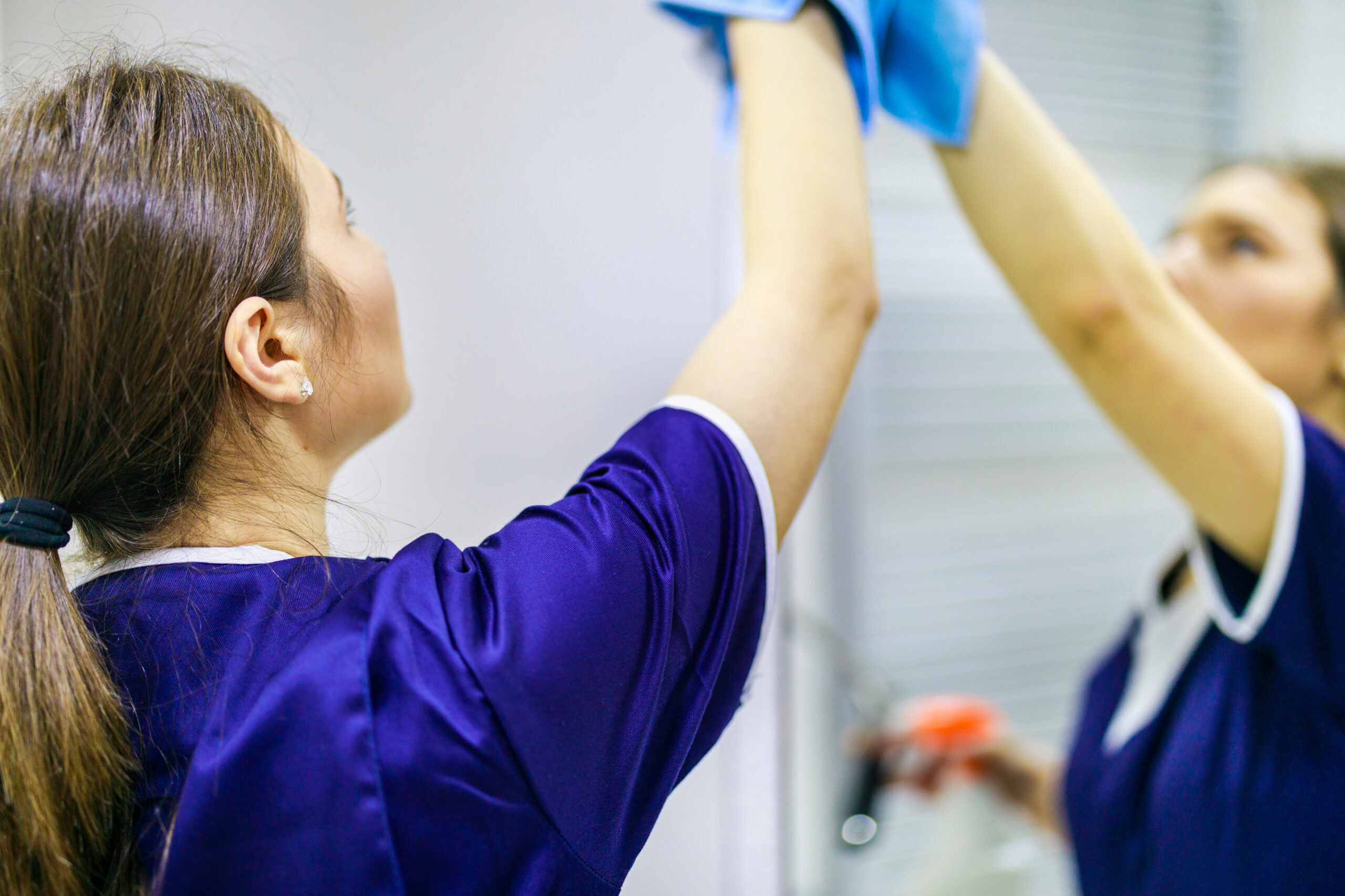 woman cleaning the mirror