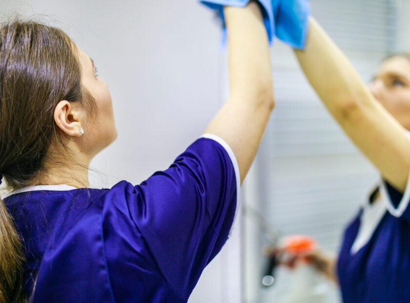 woman cleaning the mirror